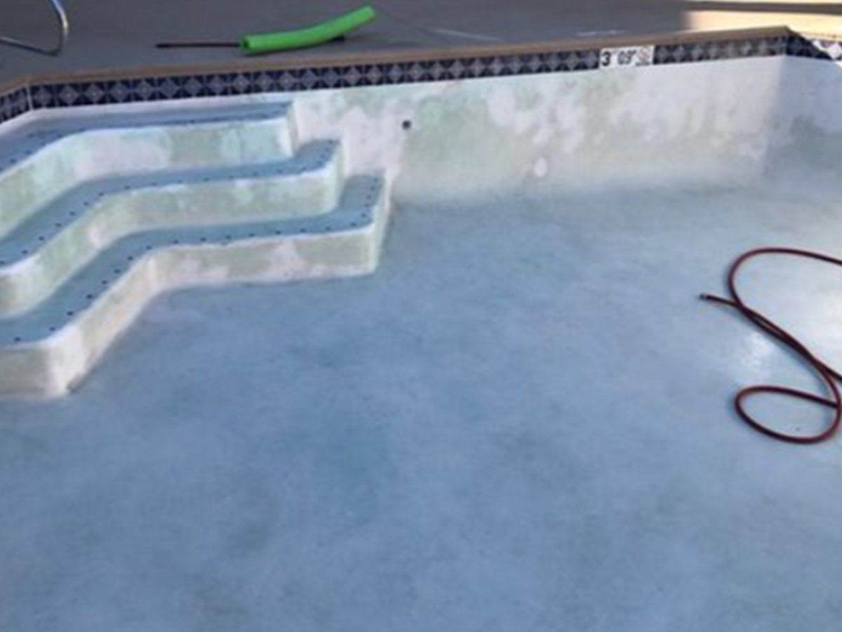 The same pool steps and floor with clean pale plaster after the acid wash