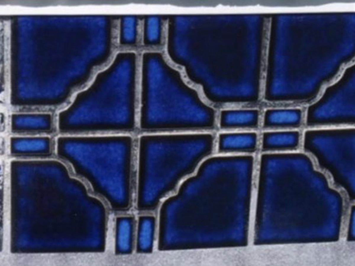 The same decorative blue pool tile with the calcium removed and the pattern visible