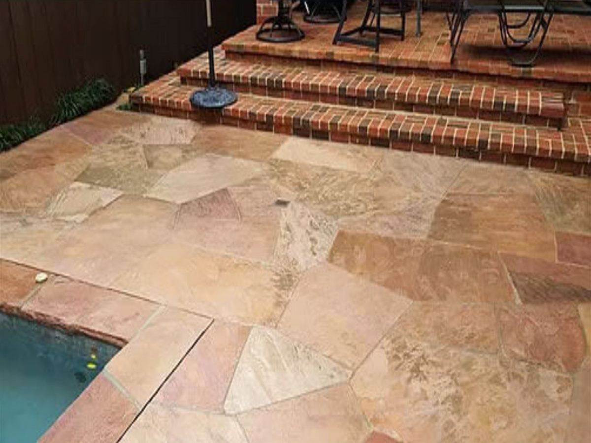 The same flagstone pool deck washed clean with the natural stone colour visible