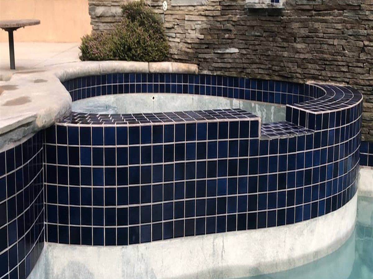 The same navy spa tile with the calcium blasted off and the glaze showing