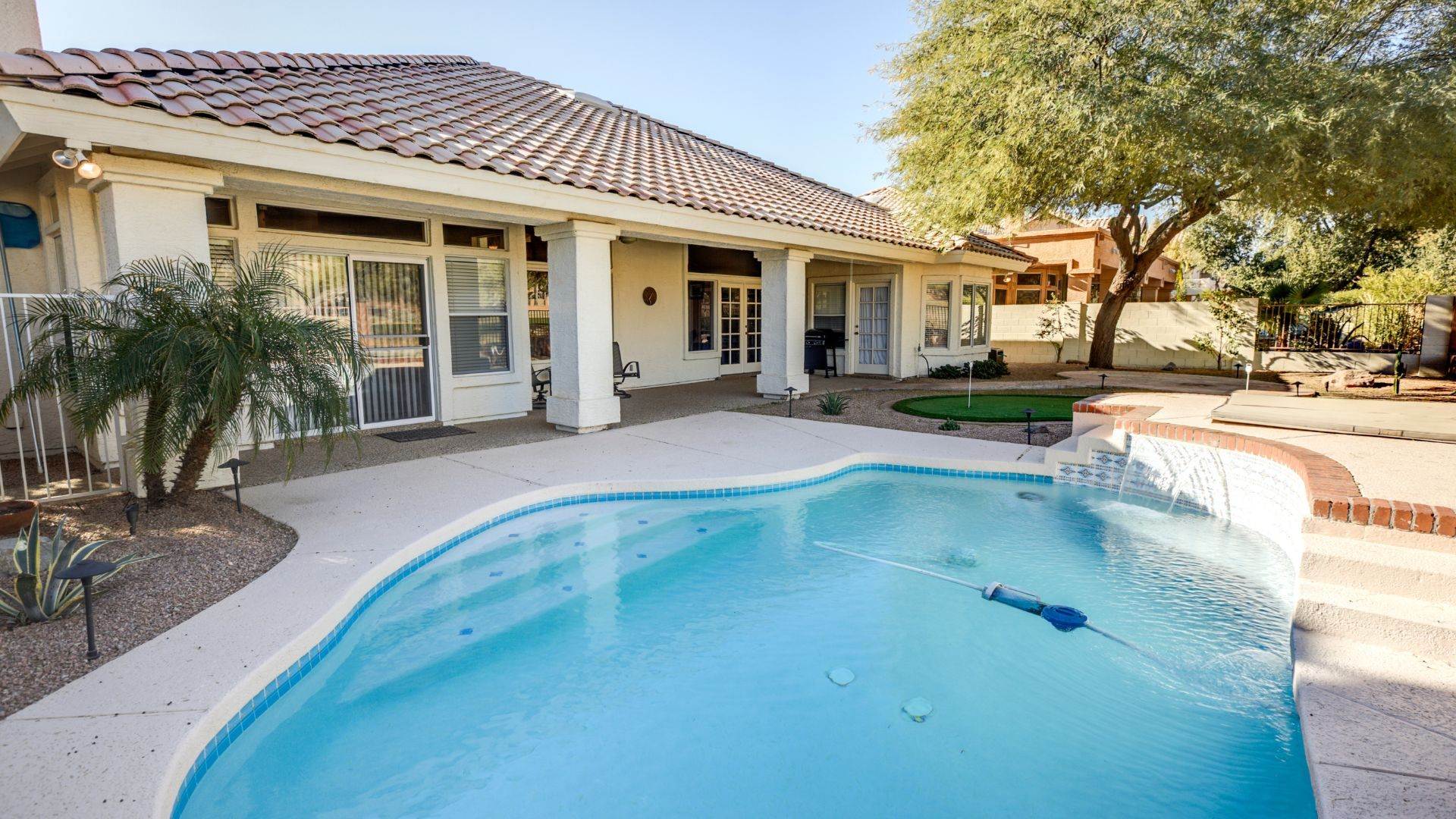 Buckeye, AZ backyard pool with a raised wall and sheer descent