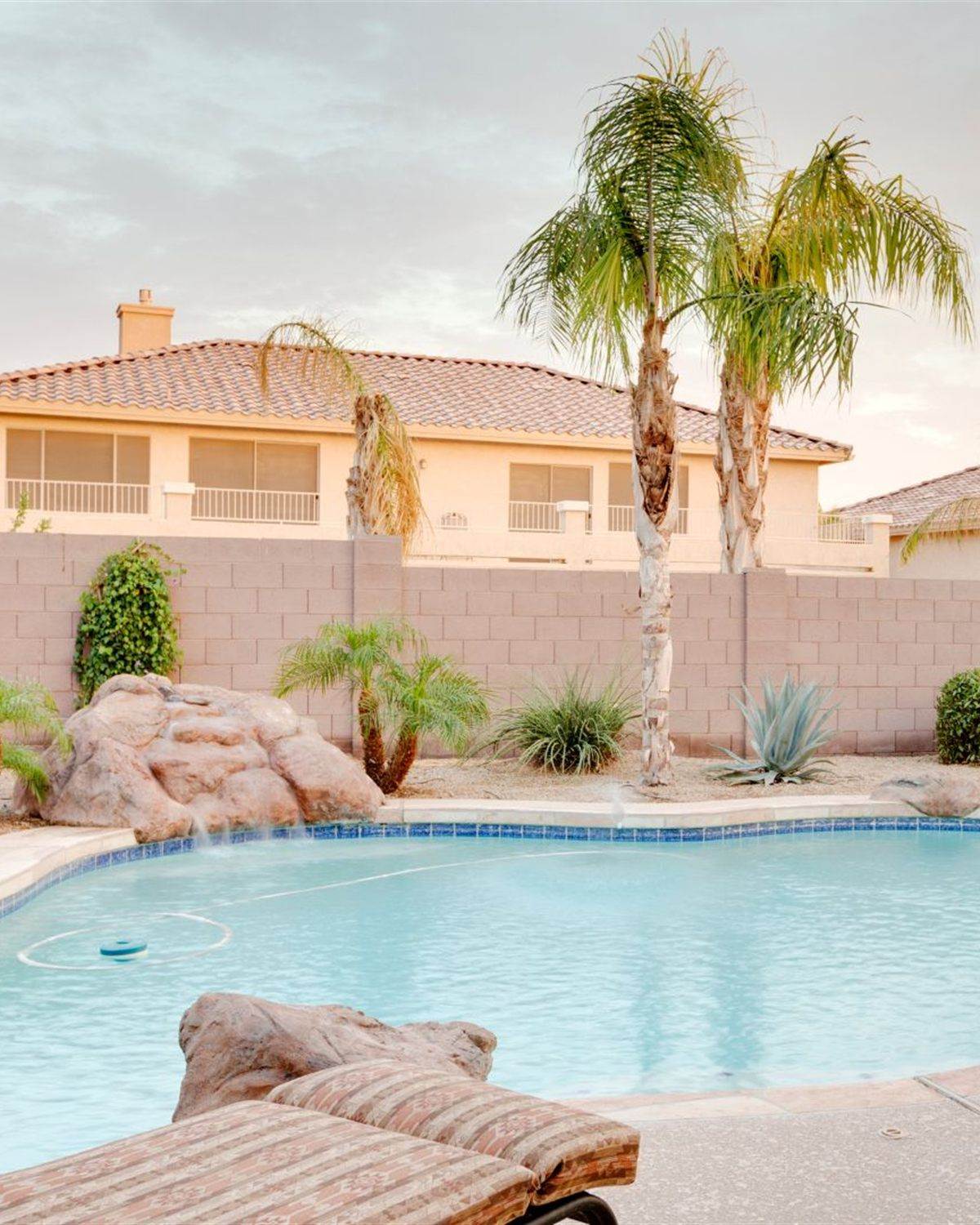 Avondale, AZ backyard pool with mature landscaping at golden hour