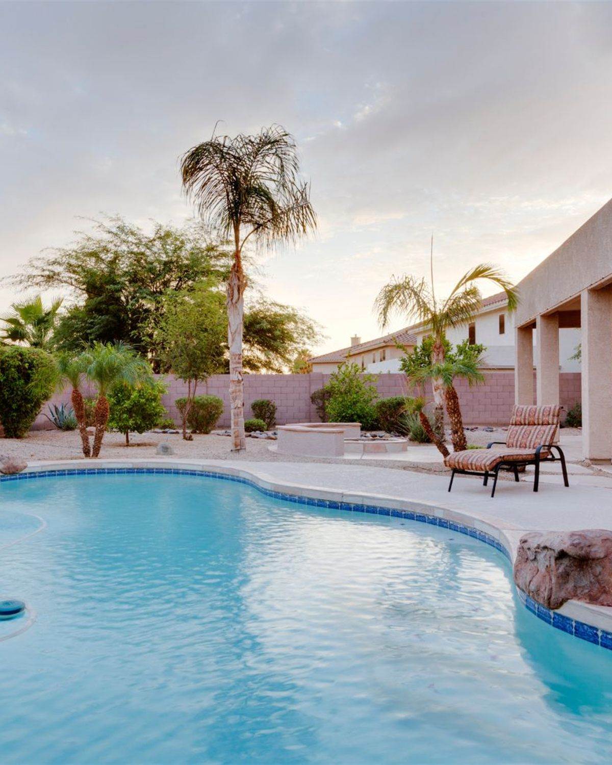 Goodyear, AZ backyard pool with desert landscaping and a covered patio