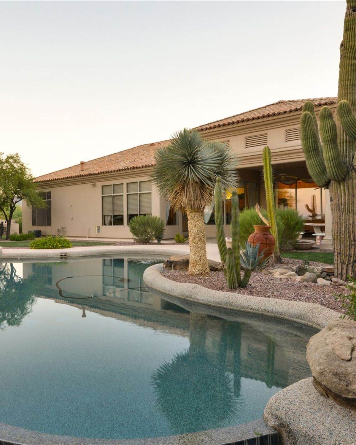 Phoenix, AZ desert home with saguaro cacti and a freeform pool