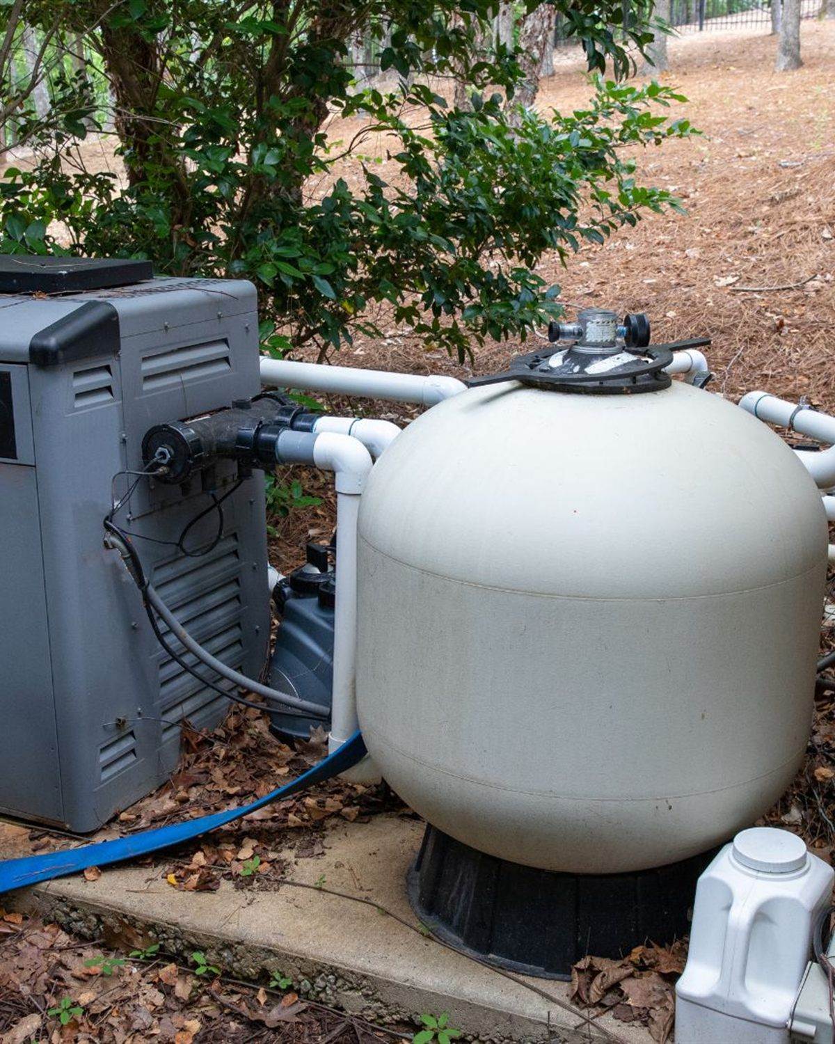 Gas pool heater and sand filter plumbed together on a residential equipment pad