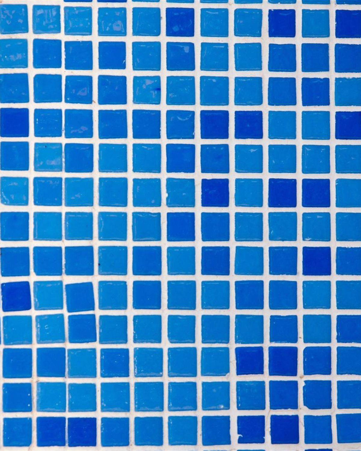 Blue and cyan square pool tiles with wide white grout lines