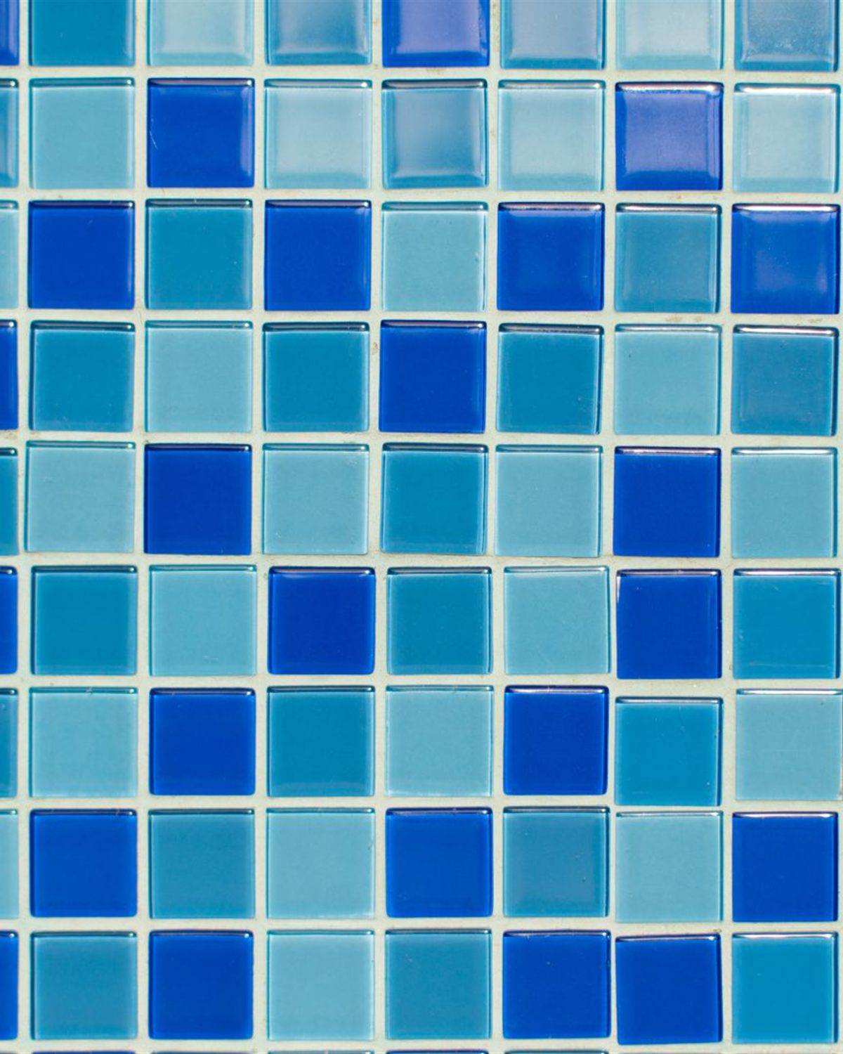 Glossy mixed blue glass mosaic tile used on pool surfaces